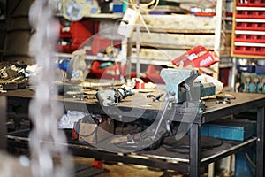 Workbench, vise. Car service. The focus is on the disks. photo